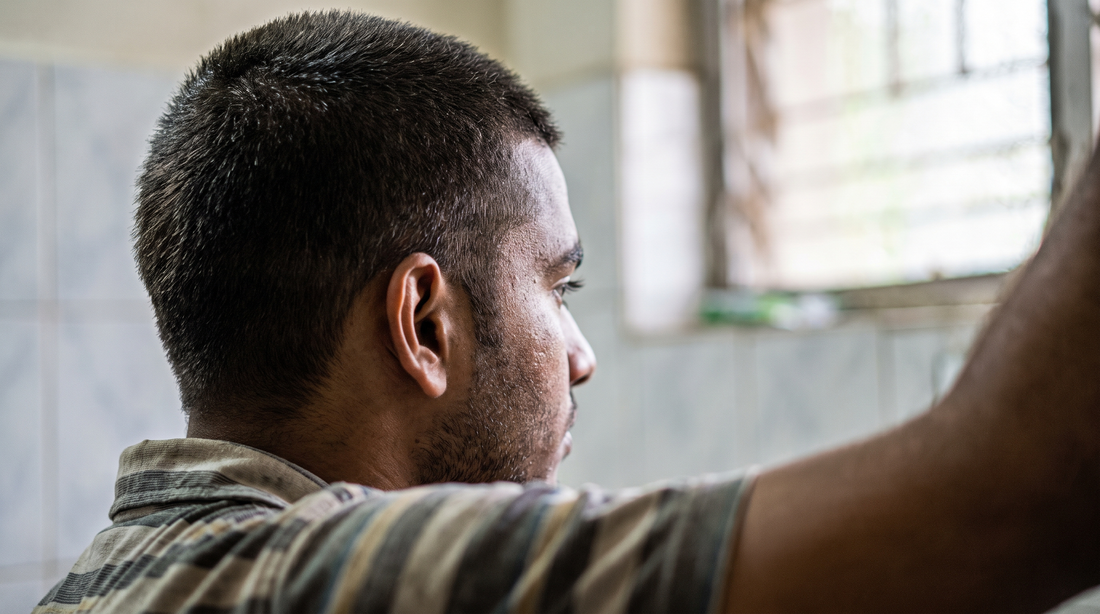 Close-up of an Indian man with a short textured crop styled in a dry matte finish, candid natural light photo